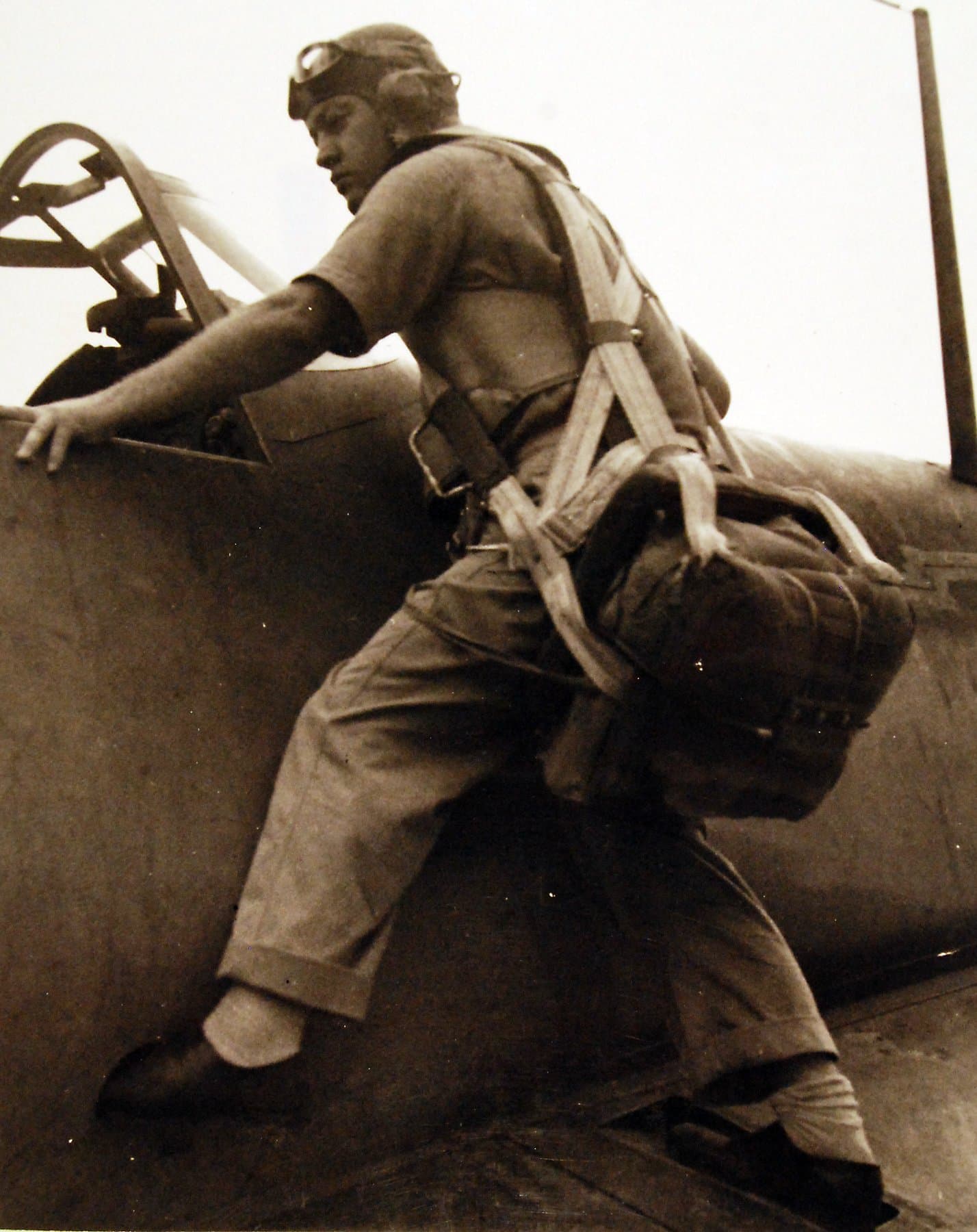 Maj. Gregory Boyington climbing into the cockpit of his F4U Corsair