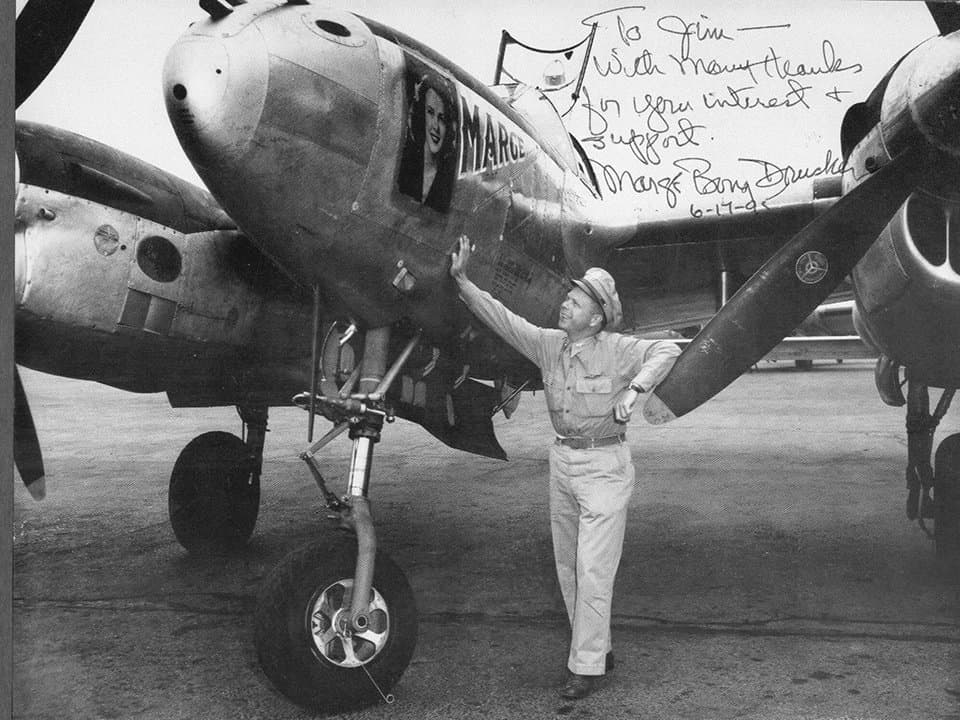Richard Bong standing in front of his P-38 Lightning named Marge